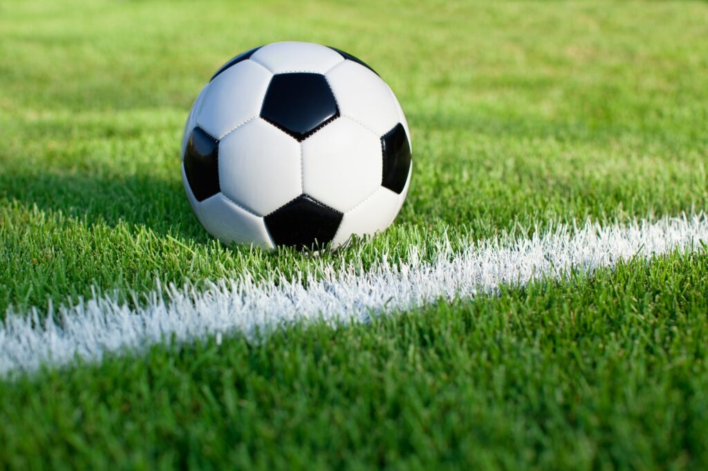 Soccer Ball on Grass Field with Stripe
